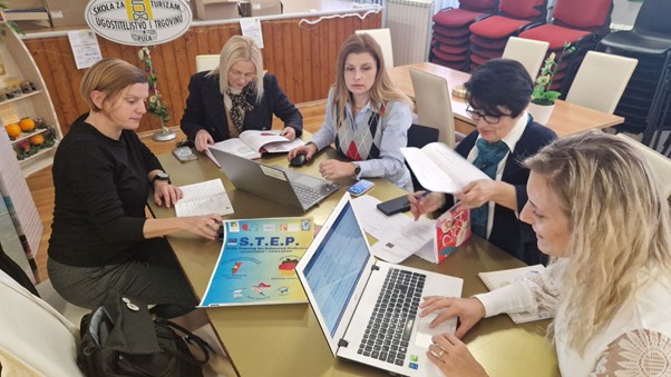 A group of people around a table with laptopsAI-generated content may be incorrect.