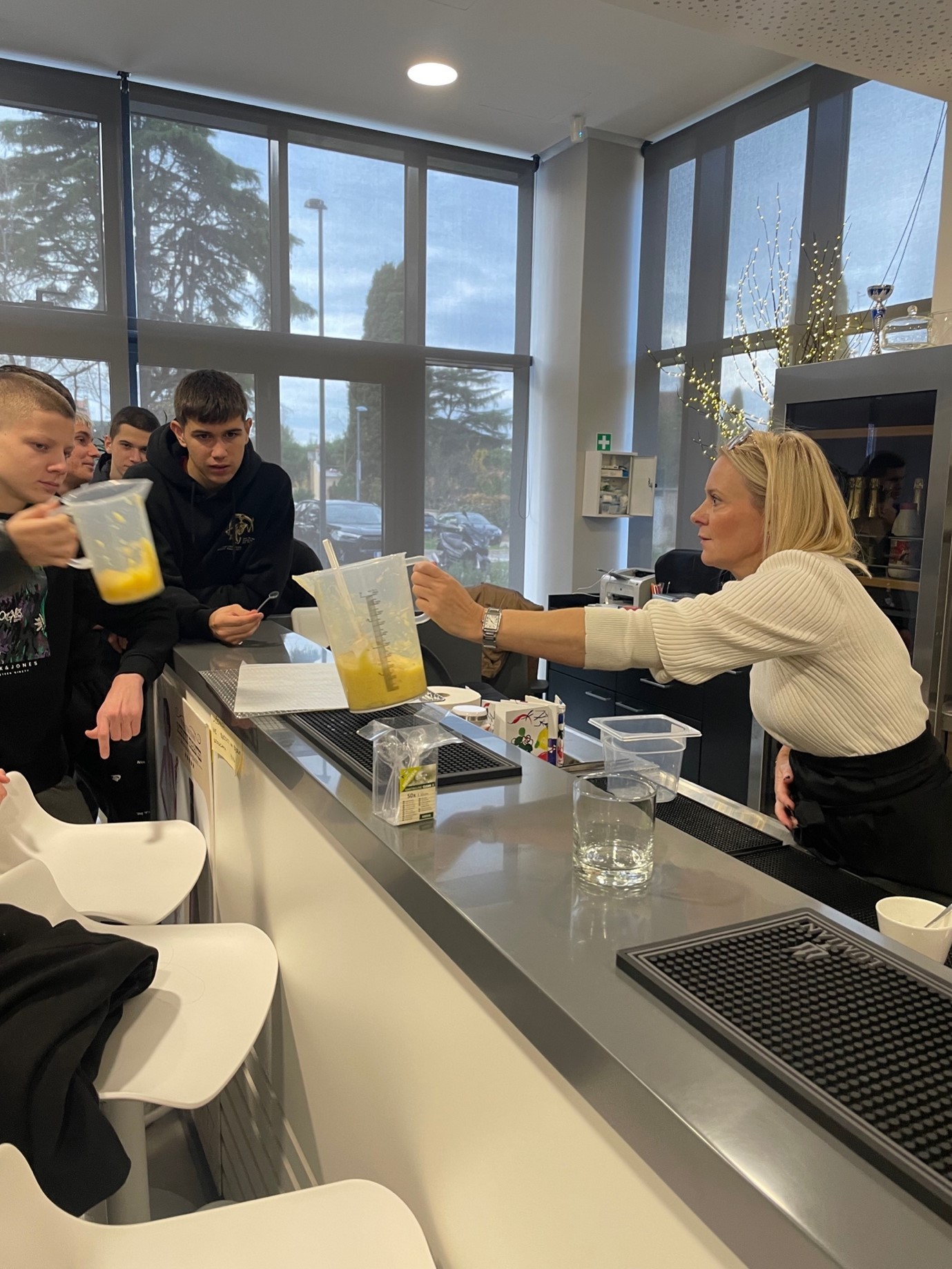 A person pouring a drink into a drinkAI-generated content may be incorrect.